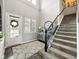 Welcoming foyer with a staircase, decorative rug, and elegant entryway details at 165 N Bend Dr, Greenwood, IN 46142