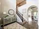 Bright foyer featuring a staircase, decorative rug, and views into the dining and living spaces at 165 N Bend Dr, Greenwood, IN 46142