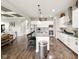 Open-concept kitchen with stainless steel appliances and a spacious island with bar stool seating at 165 N Bend Dr, Greenwood, IN 46142