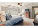 Bright main bedroom features a tray ceiling, plush bedding, and a seating area at 165 N Bend Dr, Greenwood, IN 46142