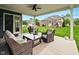 Inviting outdoor patio with comfortable seating and a ceiling fan overlooking a landscaped backyard at 165 N Bend Dr, Greenwood, IN 46142