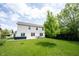 Backyard view featuring the home's exterior, well-manicured lawn and a tree at 17696 Arryne E Dr, Noblesville, IN 46062