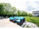 Backyard with well-manicured lawn, black fence, and outdoor seating area at 17696 Arryne E Dr, Noblesville, IN 46062