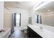 Bathroom with gray vinyl floors, shower-tub combo, and dark cabinets at 17696 Arryne E Dr, Noblesville, IN 46062