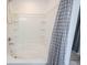 A clean white bathtub features built-in shelving and gray shower curtain at 17696 Arryne E Dr, Noblesville, IN 46062