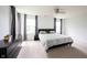 A well lit bedroom boasts carpet, neutral walls, and black furnishings at 17696 Arryne E Dr, Noblesville, IN 46062