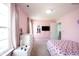 Bright bedroom with a bed, dresser, TV, and large window with neutral colored curtains at 17696 Arryne E Dr, Noblesville, IN 46062