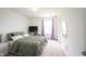 A bright bedroom with a bed, desk, and mirror provides a welcoming atmosphere at 17696 Arryne E Dr, Noblesville, IN 46062