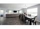 Open-concept dining area with table, chairs, and view into living space at 17696 Arryne E Dr, Noblesville, IN 46062