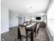 Bright dining room with view to living area, TV, and staircase at 17696 Arryne E Dr, Noblesville, IN 46062
