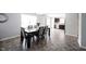 Well-lit dining room with view into modern kitchen and gray accents at 17696 Arryne E Dr, Noblesville, IN 46062