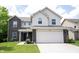 Charming two-story home with a two-car garage, landscaped yard, and a combination of brick and siding at 17696 Arryne E Dr, Noblesville, IN 46062