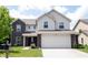 Charming two-story home with a two-car garage, landscaped yard, and a combination of brick and siding at 17696 Arryne E Dr, Noblesville, IN 46062