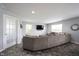 Comfortable living room features a large sectional sofa, recessed lighting, and modern finishes at 17696 Arryne E Dr, Noblesville, IN 46062