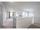 Open loft area filled with natural light, neutral carpeting and walls at 17696 Arryne E Dr, Noblesville, IN 46062