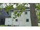 This home's exterior features white wood paneling and several windows at 1802 Woodlawn Ave, Indianapolis, IN 46203