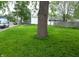 Lush front yard featuring green grass and mature trees, enhancing the property's curb appeal at 1802 Woodlawn Ave, Indianapolis, IN 46203