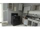 This kitchen features dark countertops and cabinetry needing repair, offering potential for renovation and customization at 1802 Woodlawn Ave, Indianapolis, IN 46203