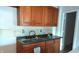 The kitchenette with oak cabinetry and modern faucet offers a functional space for easy meal preparation at 1802 Woodlawn Ave, Indianapolis, IN 46203