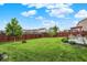 The backyard features a well-maintained lawn, a picnic table, and decorative landscaping around the privacy fence at 18258 Rickety Dr, Westfield, IN 46074