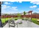 Enjoy the backyard with a firepit, pergola, seating, and lush green lawn surrounded by a privacy fence at 18258 Rickety Dr, Westfield, IN 46074