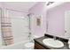 Well-lit bathroom with shower-tub combo, framed mirror, and sink with dark countertop at 18258 Rickety Dr, Westfield, IN 46074