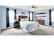 Bedroom featuring beautiful blue walls, ceiling fan, and coordinating dark blue curtains at 18258 Rickety Dr, Westfield, IN 46074