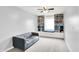 Bright bedroom with large built in shelving, a window seat, and a comfortable grey sofa at 18258 Rickety Dr, Westfield, IN 46074