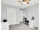 A bright bedroom featuring gray carpet, a closet, desk and a ceiling fan at 18258 Rickety Dr, Westfield, IN 46074