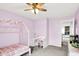 Bright bedroom features playful pink color scheme, stylish desk and canopy bed at 18258 Rickety Dr, Westfield, IN 46074