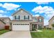 Charming two-story home with a combination of siding and brick, enhanced by dark shutters and a well-manicured lawn at 18258 Rickety Dr, Westfield, IN 46074