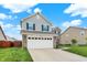Charming two-story home with a combination of siding and brick, enhanced by dark shutters and a well-manicured lawn at 18258 Rickety Dr, Westfield, IN 46074