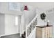 Bright foyer with white staircase and neutral walls, adorned with decorative accents at 18258 Rickety Dr, Westfield, IN 46074