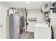Functional laundry room with washing machine, dryer, water heater, and ample storage space at 18258 Rickety Dr, Westfield, IN 46074