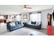 Spacious living room with modern gray flooring, comfortable seating, and an open layout to the dining area at 18258 Rickety Dr, Westfield, IN 46074