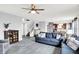 Open-concept living room with plush seating, modern flooring, and a seamless transition to the dining area at 18258 Rickety Dr, Westfield, IN 46074