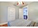 Inviting bedroom with great natural light offering an open doorway, hardwood flooring, and a ceiling fan at 1867 Barth Ave, Indianapolis, IN 46203