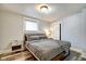 Comfortable bedroom with wood-look flooring, a window, and a cozy queen bed at 1867 Barth Ave, Indianapolis, IN 46203