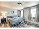 Comfortable bedroom with gray tones, laminate floors, two windows, a ceiling light, and a spacious closet at 1867 Barth Ave, Indianapolis, IN 46203
