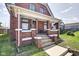 Inviting brick home with a covered front porch, perfect for enjoying the outdoors at 1867 Barth Ave, Indianapolis, IN 46203