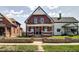 Charming two-story brick home featuring a quaint front porch and well-maintained lawn at 1867 Barth Ave, Indianapolis, IN 46203