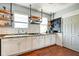 This kitchen features bright natural light, stainless appliances, modern cabinets, and wood flooring at 1867 Barth Ave, Indianapolis, IN 46203