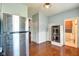 Galley kitchen featuring stainless steel appliances, warm wood flooring and access to a bathroom at 1867 Barth Ave, Indianapolis, IN 46203