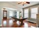 Bright living room featuring hardwood floors, a ceiling fan, and large windows, offering a welcoming space at 1867 Barth Ave, Indianapolis, IN 46203