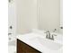 Bathroom featuring a white sink, dark wood cabinets, a toilet, and a mirror at 19725 Highclere Lane, Sheridan, IN 46069