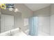 Clean bathroom with a shower-tub combo, framed print, and bright vanity at 19725 Highclere Lane, Sheridan, IN 46069