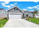 Single-Gathering home boasting a well-manicured lawn and a two-car garage with driveway at 19725 Highclere Lane, Sheridan, IN 46069