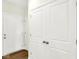 Hallway featuring hardwood floors, white walls, white doors, and a set of double doors leading to a closet at 19725 Highclere Lane, Sheridan, IN 46069