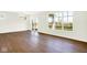 Living room with hardwood floors, a chandelier, and large windows with a view of the yard at 19725 Highclere Lane, Sheridan, IN 46069