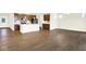 Bright, open-concept living space with wood floors, leading to a modern kitchen with stainless steel appliances at 19725 Highclere Lane, Sheridan, IN 46069